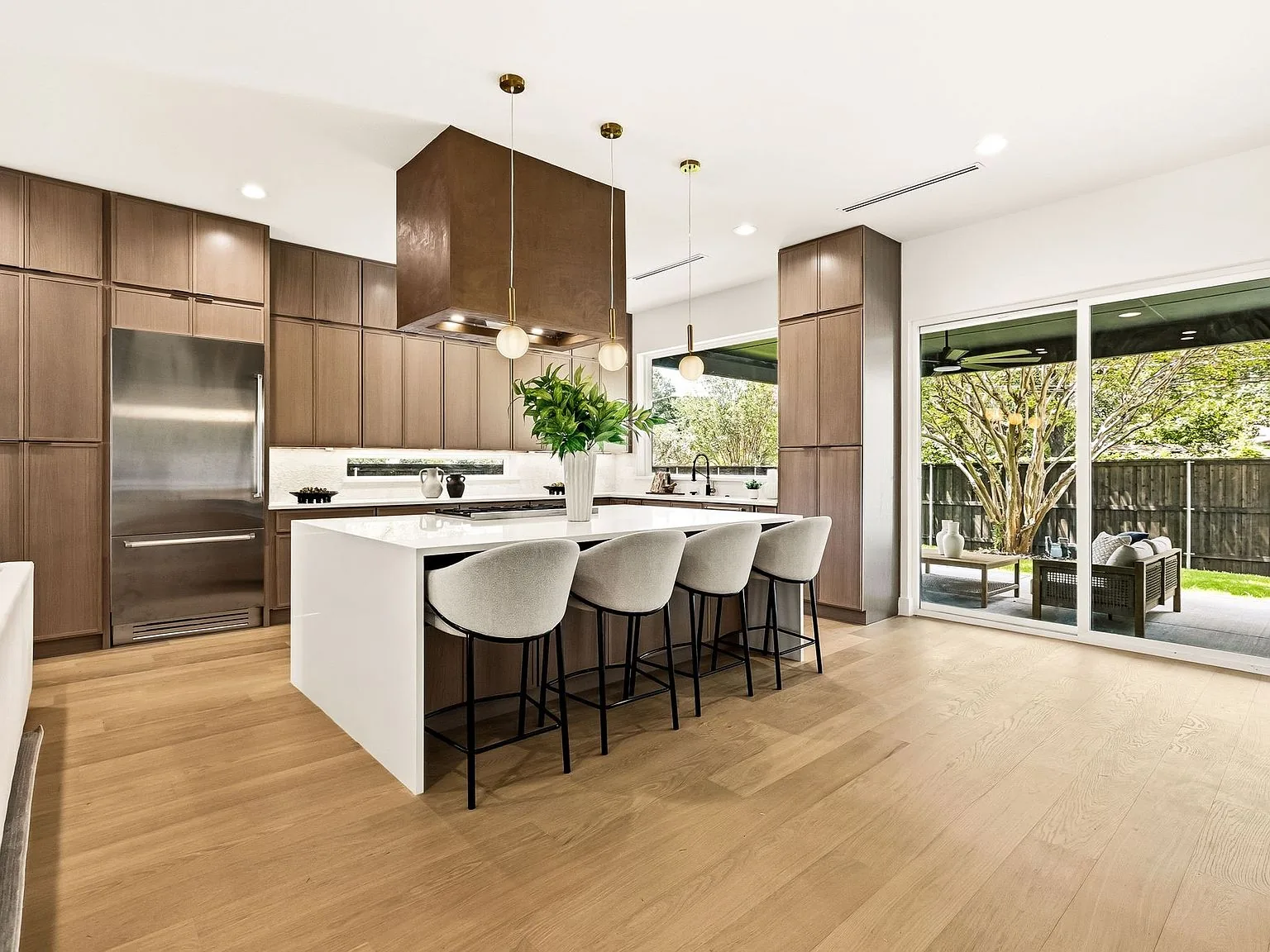 Custom kitchen with marble backsplash in a new construction Dallas residence